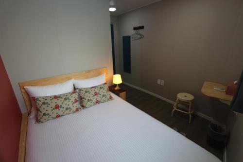 a bedroom with a large bed with two pillows at HAH Guesthouse in Seoul
