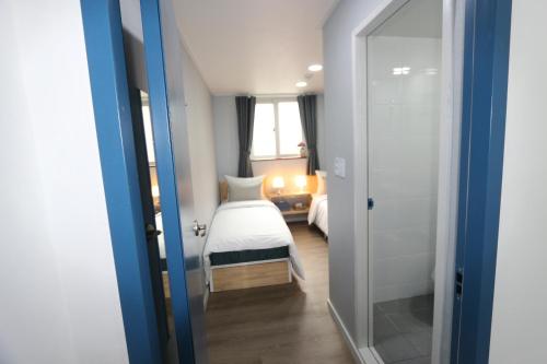 a hotel room with a bed and a window at HAH Guesthouse in Seoul
