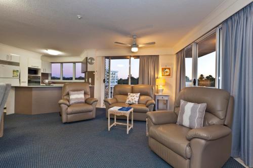 a living room with two chairs and a couch at Meridian Tower Kirra Beach in Gold Coast