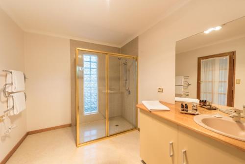a bathroom with a shower and a sink at Parnella Kettering in Kettering
