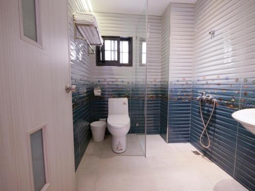 a bathroom with a toilet and a sink at Miss inn in Magong