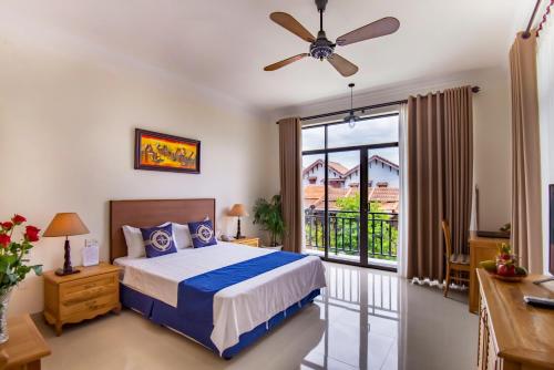 a bedroom with a bed and a balcony at Santa Sea Villa in Hoi An