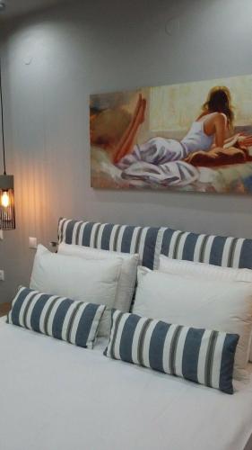 a row of pillows on a bed in a room at Katsenos studios in Nikiana