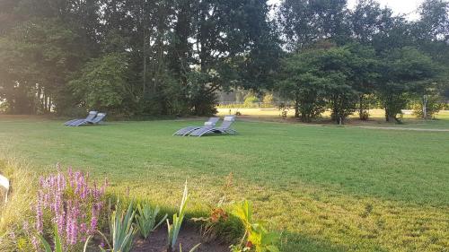 two picnic tables in a field in a park at Schaluinenhoeve in Baarle-Nassau