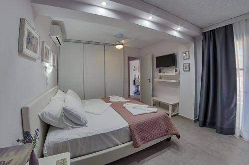 A bed or beds in a room at Irida Holiday Apartments
