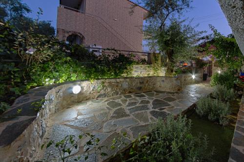 a stone walkway with a building in the background at Irida Holiday Apartments in Stoupa