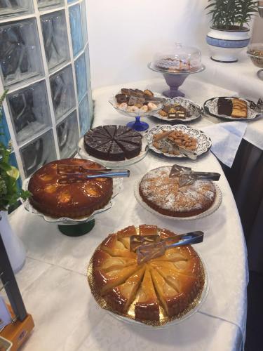 a table with many cakes and desserts on it at Hotel Terramare in Lido di Jesolo