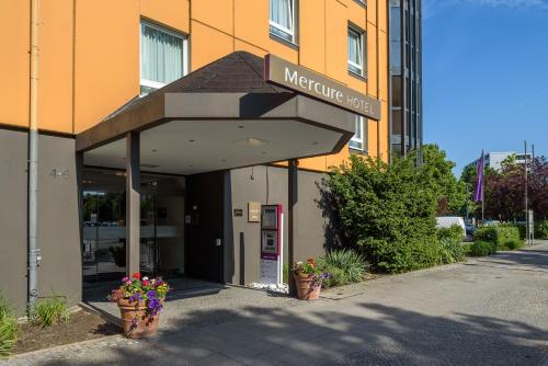 a sign for a methine hotel in front of a building at Mercure Hotel Berlin City West in Berlin