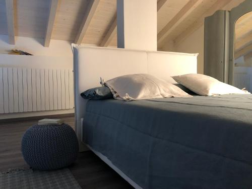 a bedroom with a large bed with two pillows at Ma maison art in Brovello-Carpugnino