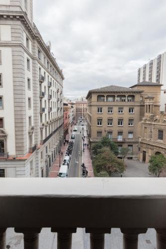 a view of a city street from a balcony at Hotel Oriente in Zaragoza