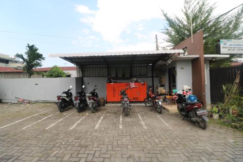 a group of motorcycles parked in front of a building at RedDoorz @ Jalan Krakatau Medan in Medan