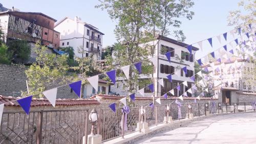 a street with blue and white flags on a fence at Çamlıca Konak Çarsı in Safranbolu