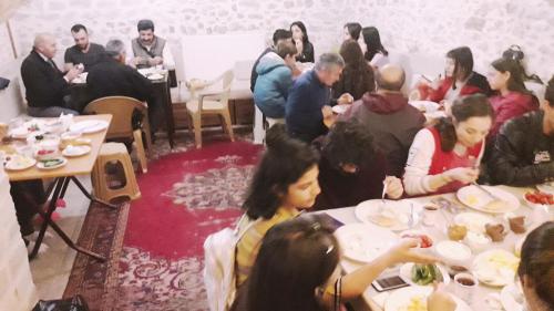 a group of people sitting at tables eating food at Çamlıca Konak Çarsı in Safranbolu