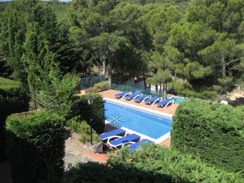 an image of a swimming pool with chairs and trees at Belvilla by OYO La Pineda in Begur