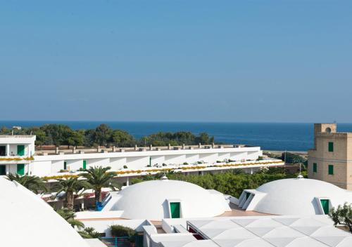 an aerial view of the resort with the ocean in the background at Corvino Resort in Monopoli