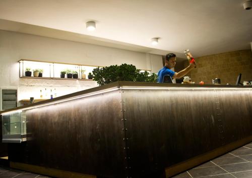 a man standing behind a counter in a kitchen at Corvino Resort in Monopoli
