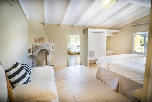 a bedroom with a bed and a fireplace at Parthenis Hotel & Suites in Malia
