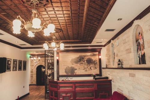 a room with a large painting on the wall at Hotel Kastro in Gjirokastër