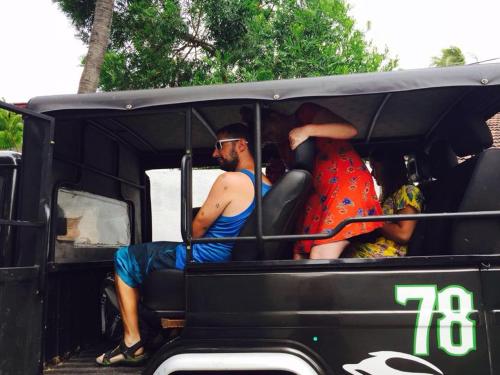 a man and woman sitting in the back of a golf cart at Sanctuary Cove Guest House in Polonnaruwa