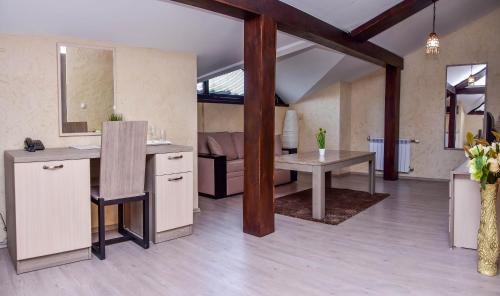 a kitchen with a table and a dining room at Hotel Izvora 2 in Arbanasi