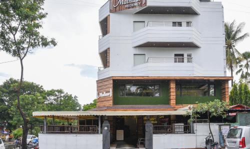 a building with a restaurant in front of it at Treebo Trend Malhaar Regency in Pune