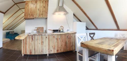 a kitchen with a wooden counter and a table at Cisarska sadyba in Svityazʼ
