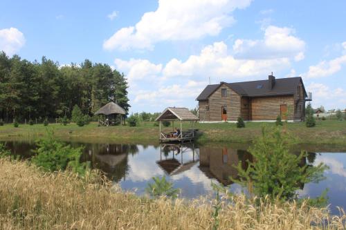 a house on the shore of a lake at Cisarska sadyba in Svityazʼ