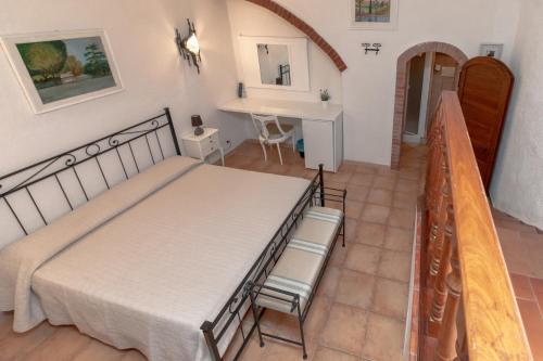 a bedroom with a bed and a table and chairs at Casale Gli Ulivi in Orbetello