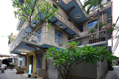 a building with balconies and plants on it at Chikan West House in Tainan