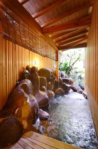 a room with a stream of water with rocks at AKARI et KAORI formerly Taizanso in Izu