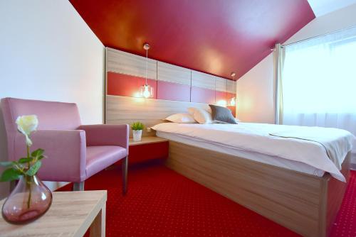 a bedroom with a large bed and a purple ceiling at GreenWood Residence in Timişoara