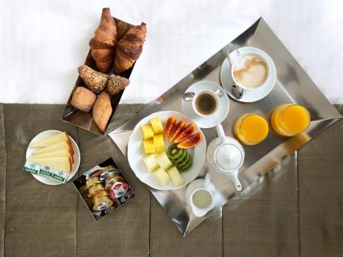 a table with a tray of breakfast foods and coffee at Casa Montani in Rome