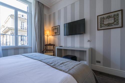 a bedroom with a bed and a television on the wall at Casa Montani in Rome