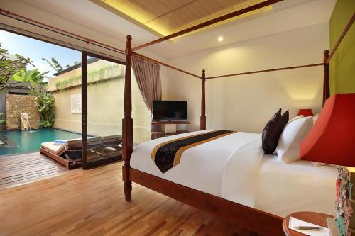 a bedroom with a bed and a swimming pool at Kamajaya Villas in Ubud