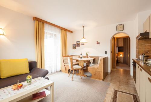 a living room with a couch and a table at Haus Bergesblick in Leutasch