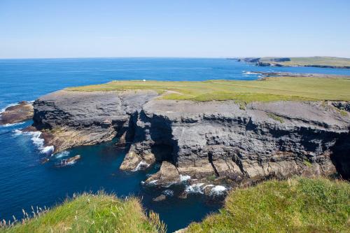 an aerial view of a rocky island in the ocean at Kilkee Holiday Homes Type A by Trident Holiday Homes in Kilkee