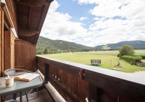 a balcony with a table and a view of a field at Haus Bergesblick in Leutasch