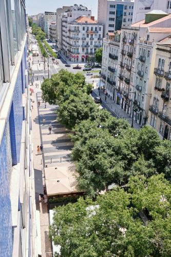 an overhead view of a city street with trees at Patria Hotel in Lisbon