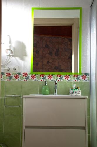 a bathroom with a sink and a mirror at casa oliva la bodegueta in Abiego