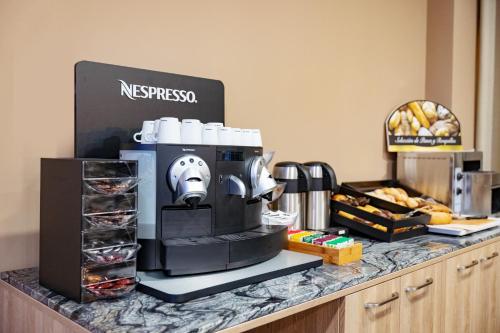 a coffee maker sitting on top of a counter at Hotel Admiral San Roque in San Roque