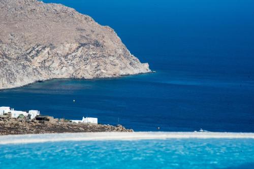 a group of buildings on a island in the ocean at Amallini Suites Mykonos in Super Paradise Beach
