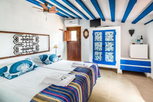 a bedroom with a large bed with blue ceilings at Monte Pedras Negras in São Luis