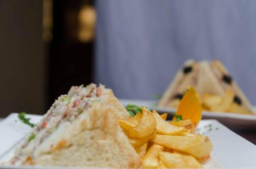 a sandwich and french fries on a white plate at Getfam Hotel in Addis Ababa