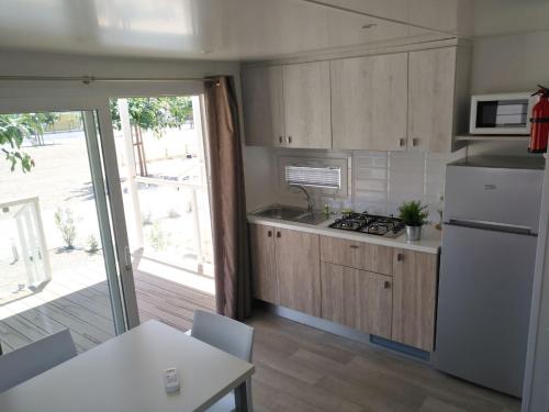 a kitchen with a refrigerator and a stove top oven at ReBi Village in Imperia