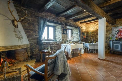 a dining room with tables and chairs in a building at Complejo Rural Lar de Vies in A Pontenova