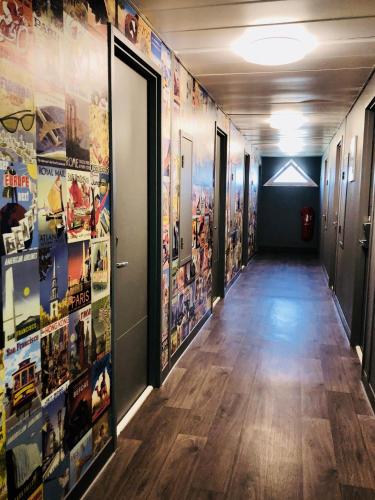 a hallway with many posters on the walls at hotelF1 Genève Aéroport Ferney in Ferney-Voltaire