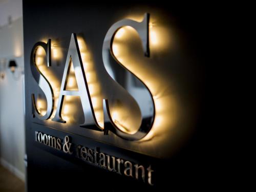 a sign for a restaurant with the word ash on it at SAS rooms & restaurant in Lublin