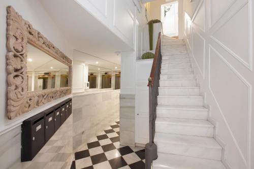 a white staircase with a checkered floor at Enjoybcn Dali Apartments in Barcelona