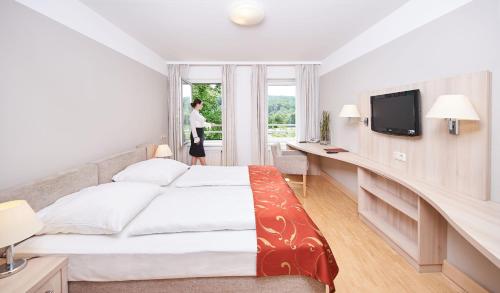 a hotel room with a bed and a window at Europahaus Wien in Vienna