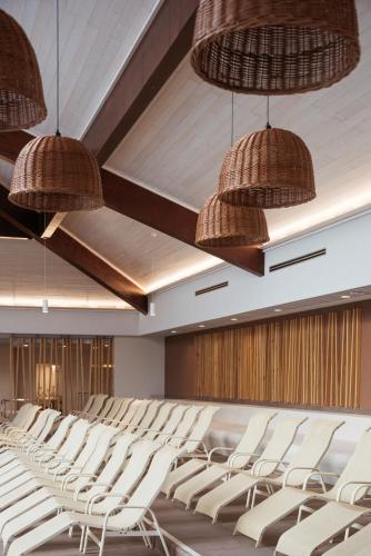an empty lecture hall with white chairs and baskets at Hotel Termal - Terme 3000 - Sava Hotels & Resorts in Moravske Toplice